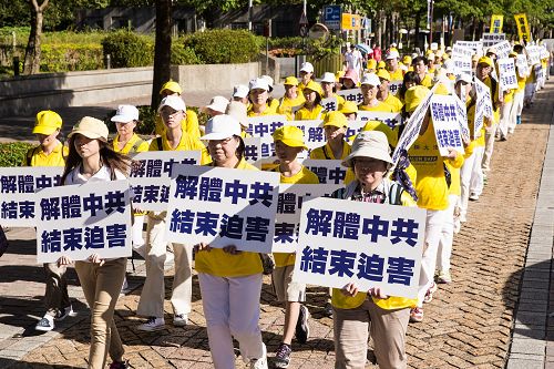 学员们手持“千古奇冤”、“解体中共结束迫害”等横幅与标语，呼吁解体中共，停止迫害。