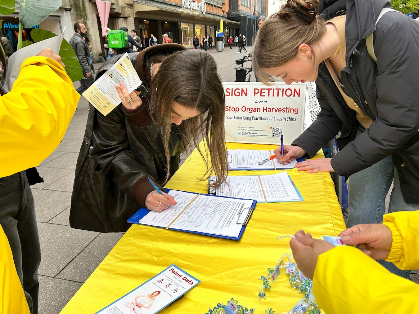 '图4~6:游人在反对活摘器官征签板上签名'