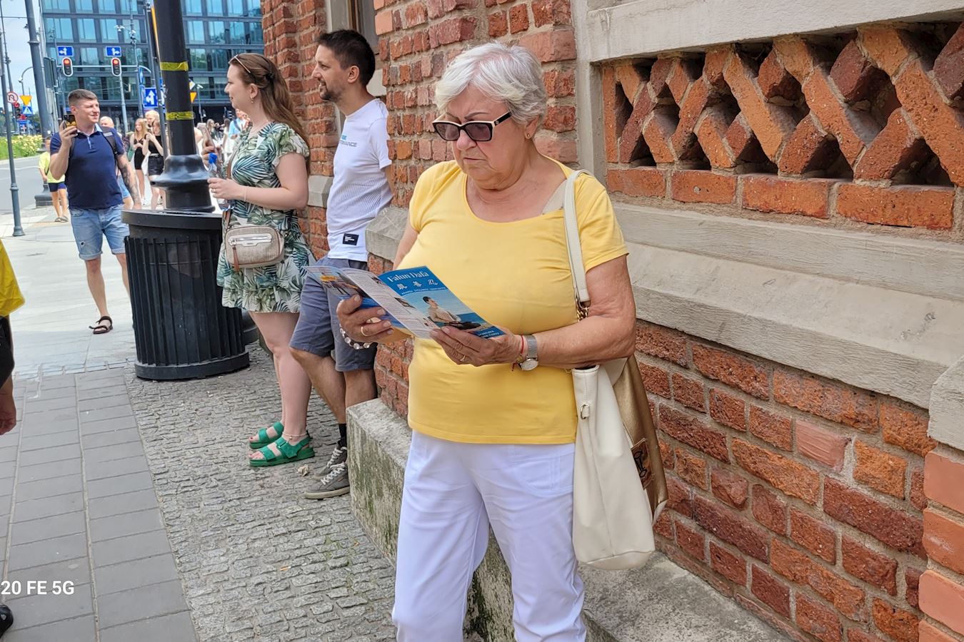 '图18~19:到处可见认真阅读法轮功传单的市民'